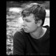 black and white portrait of a young man at a rivers edge maine