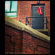 american flag caught in school door of brick building