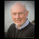 Environmental business head shot of an older gentleman wearing glasses